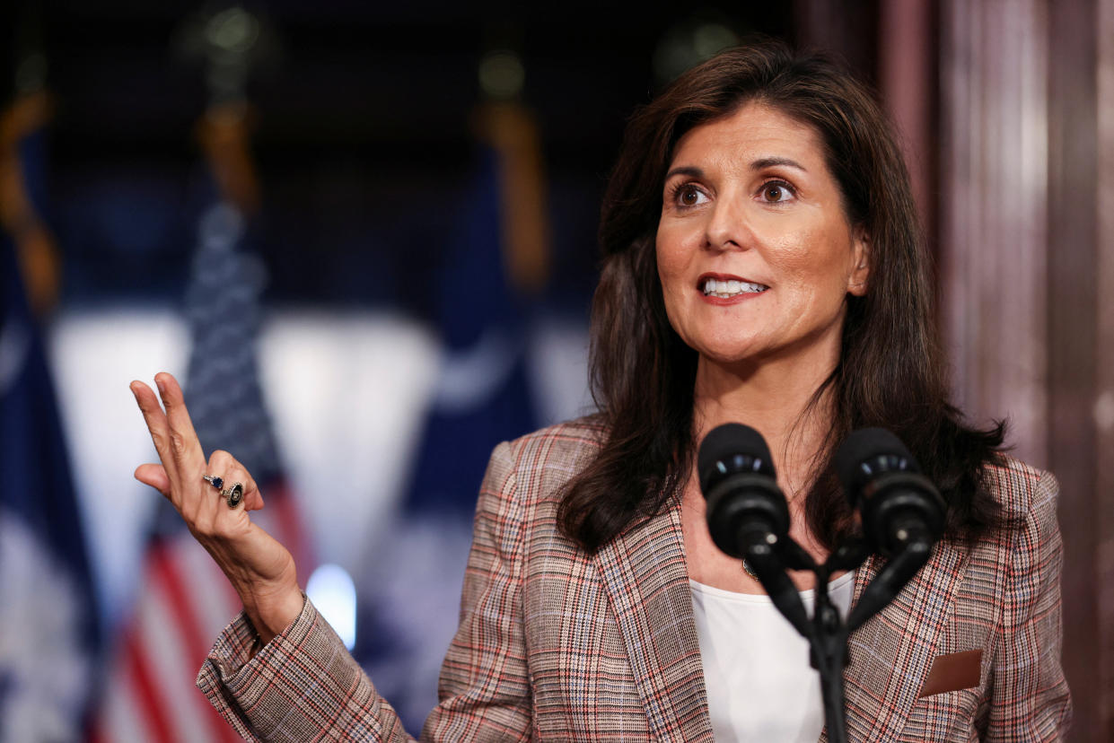 Nikki Haley stands at a pair of microphones.