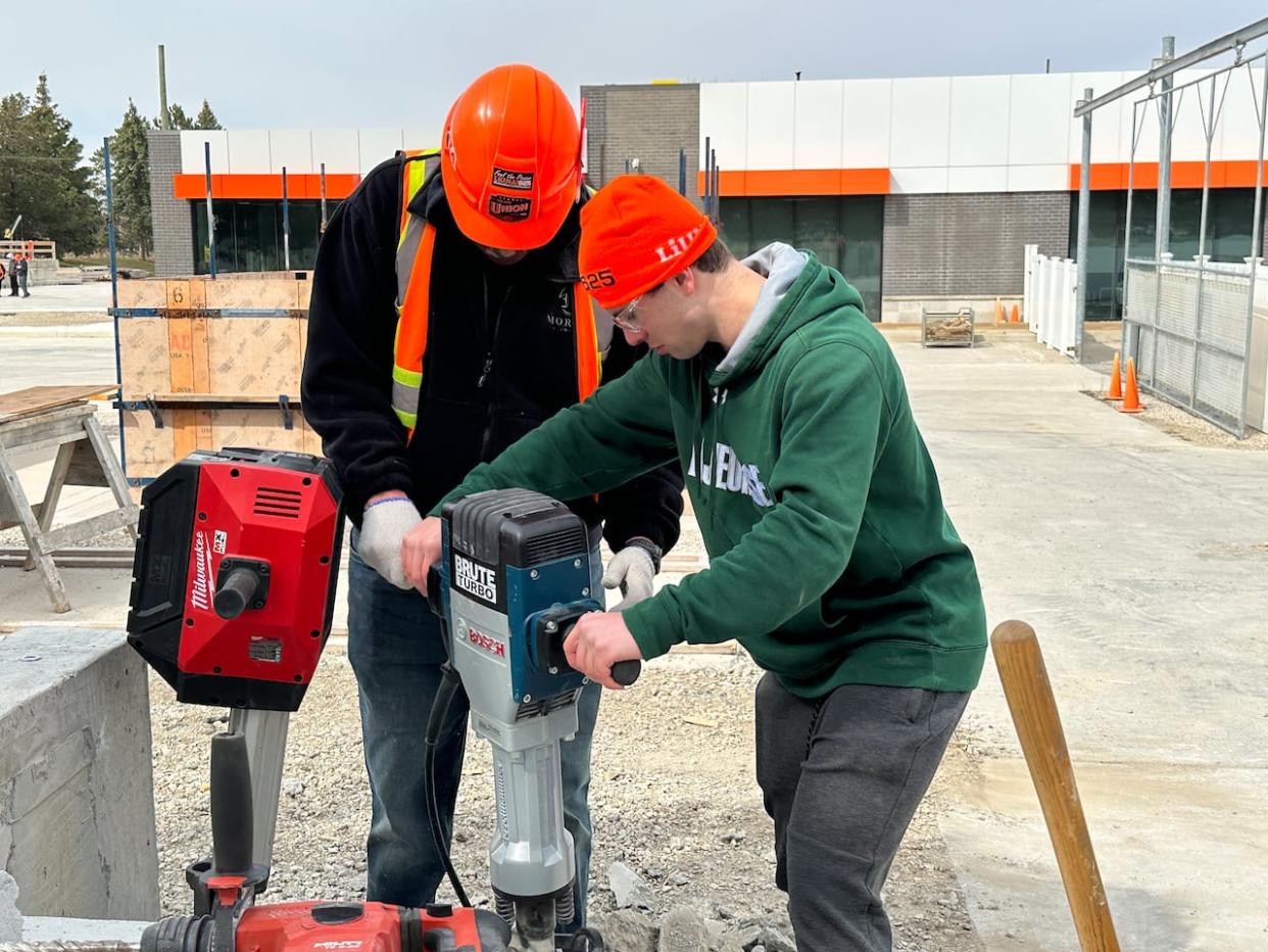 Braeden Comtois from École secondaire catholique E.J. Lajeunesse tries out a jackhammer at LiUNA Local 625 as part of Workforce Windsor-Essex's industry tour day. More than 500 students participated.  (Dale Molnar/CBC - image credit)