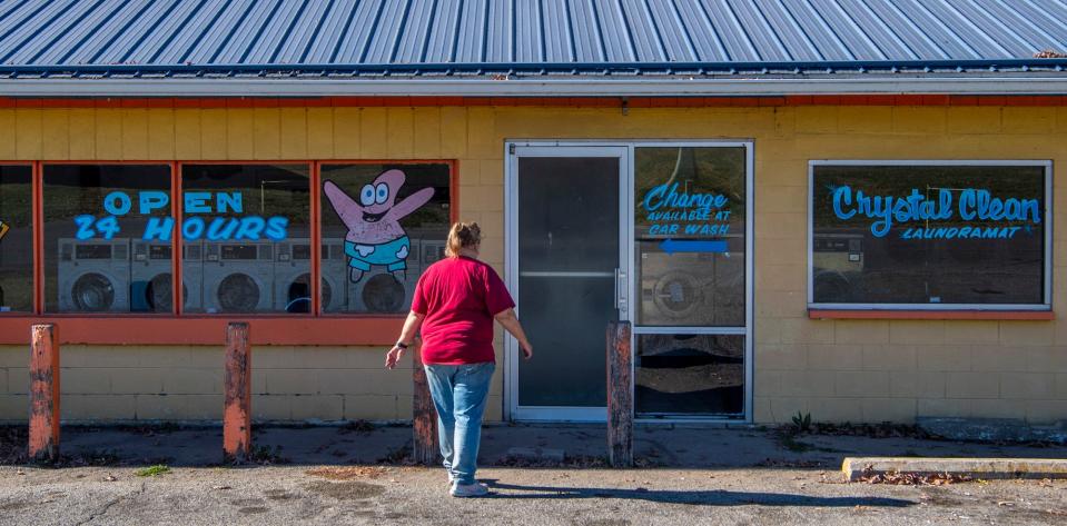 Cindy Marker, co-owner of Crystal Clean Laundromat in Gosport, heads inside. The Markers own two of the biggest water-using businesses in town.