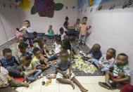 Children from families of illegal African immigrants gather at a so-called day-care centre in southern Tel Aviv, on May 28, 2015