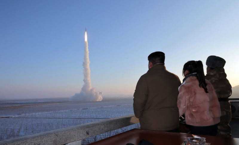 A picture released by the North Korean state news agency (KCNA) on December 19, 2023, shows Kim Jong Un (L), North Korea's ruler, and his daughter Ju Ae (2nd L) watching a test of a nuclear-capable Hwasong-18 intercontinental ballistic missile (ICBM) at an undisclosed location on December 18, 2023. North Korea has fired a long-range nuclear-capable missile that could theoretically reach the US mainland, according to its neighbours South Korea and Japan. -/KCNA/KNS/dpa