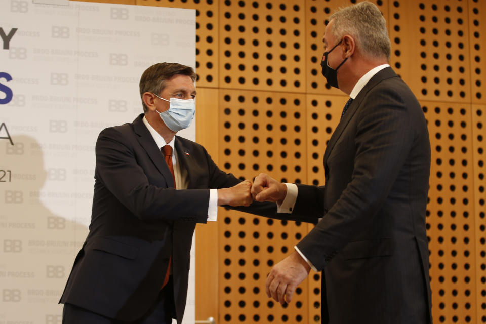 Slovenia's President Borut Pahor, left, welcomes Montenegro's President Milo Djukanovic at the Brdo-Brijuni summit, in Brdo, Slovenia, Monday, May 17, 2021. The Brdo-Brijuni Process summit had originally been planned for last year, to coincide with the 10th anniversary of the initiative, but had been postponed twice due to the coronavirus pandemic. (AP Photo/Darko Bandic)