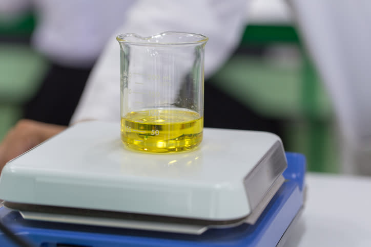 A small volume of biodiesel being weighed on a scale in the lab.