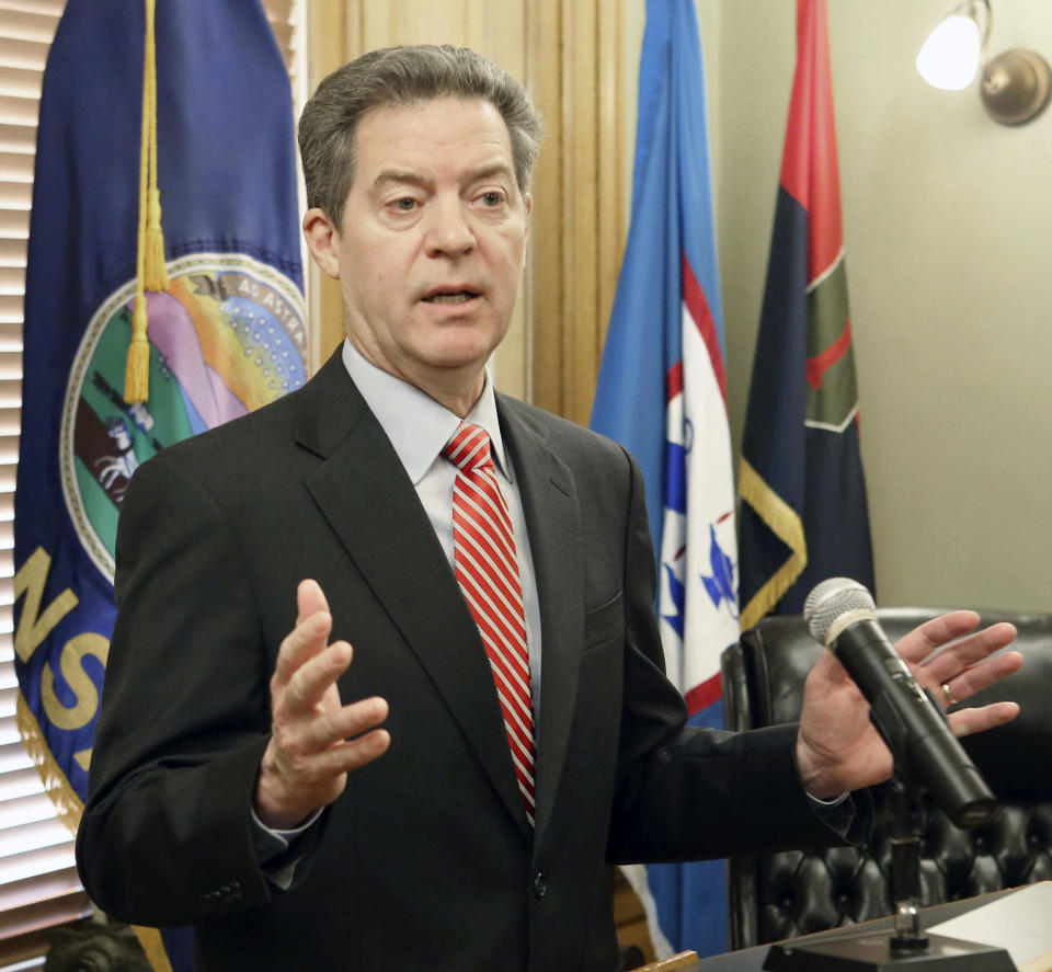 Gov. Sam Brownback takes questions from the media after signing the veto of the tax bill sent to him from the legislature, Wednesday, Feb. 22, 2017. (Thad Allton /The Topeka Capital-Journal via AP)