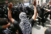 <p>Protesters face off with riot police escorting conservative activists following a march in Boston against a planned ‘Free Speech Rally’ just one week after the violent ‘Unite the Right’ rally in Virginia left one woman dead and dozens more injured on August 19, 2017 in Boston, Mass. (Photo: Spencer Platt/Getty Images) </p>