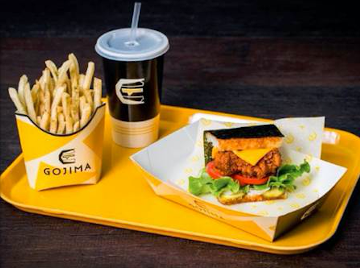 This gourmet bun-less Japanese rice burgers have crispy chicken, cheese, tomato, lettuce with Gojima’s miso sauced – wrapped in Japanese sushi rice and nori. Photo: Supplied/Gojima