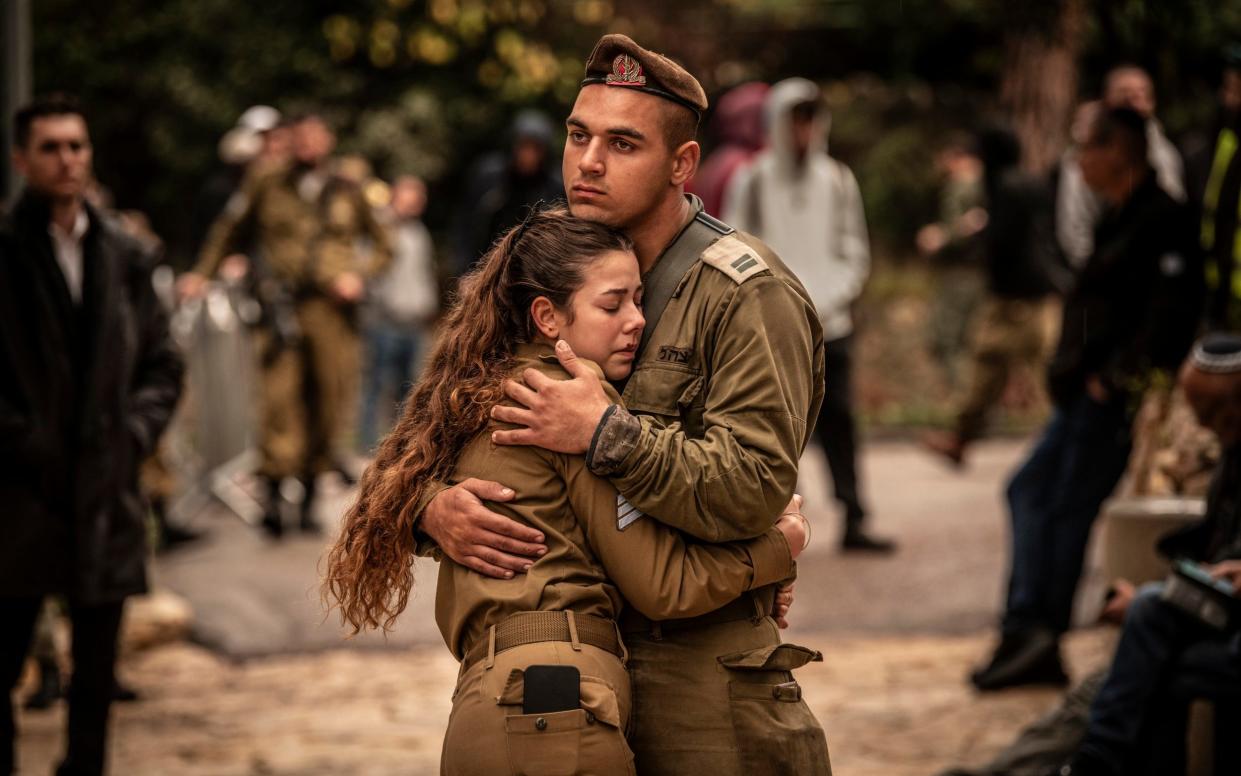 Soldiers mourn at the funeral of Lt Col Tomer Grinberg, who was killed in battle along with several soldiers in Shejaiya, Gaza, yesterday