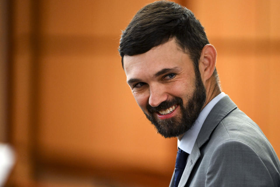 Christopher Burbank smiles at friends and family in the gallery during the trial of Tacoma Police Officers Christopher Burbank, Matthew Collins and Timothy Rankine in the killing of Manny Ellis at Pierce County Superior Court, Tuesday, Oct. 10, 2023, in Tacoma, Wash. (Brian Hayes/The News Tribune via AP, Pool)