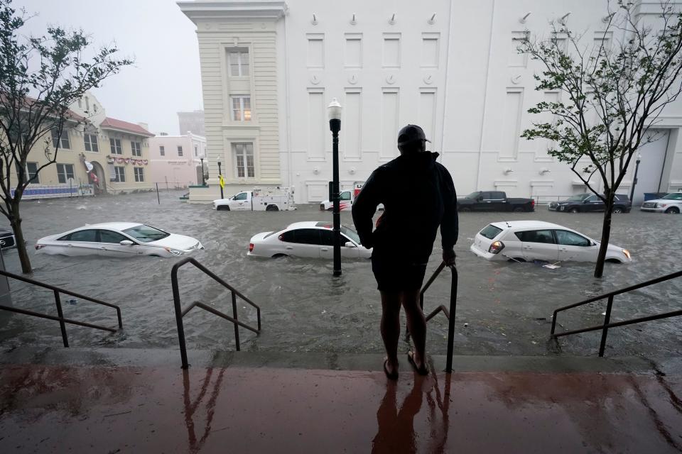Flood waters move on the street, Wednesday, Sept. 16, 2020, in downtown Pensacola, Fla.