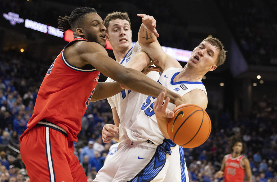 St. John's Zuby Ejiofor, left, battles for a rebound against Creighton's Ryan Kalkbrenner, rear center, and Baylor Scheierman during the first half of an NCAA college basketball game Saturday, Jan. 13, 2024, in Omaha, Neb. (AP Photo/Rebecca S. Gratz)