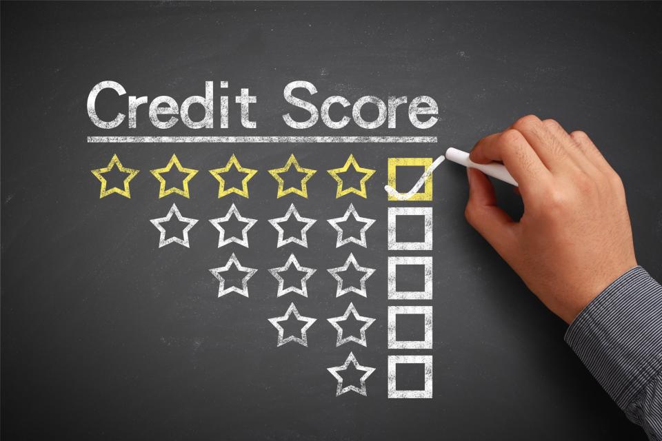 Credit score written on chalkboard; underneath, a box is checked next to five stars; rows with four, three, two, and one star are below, unchecked