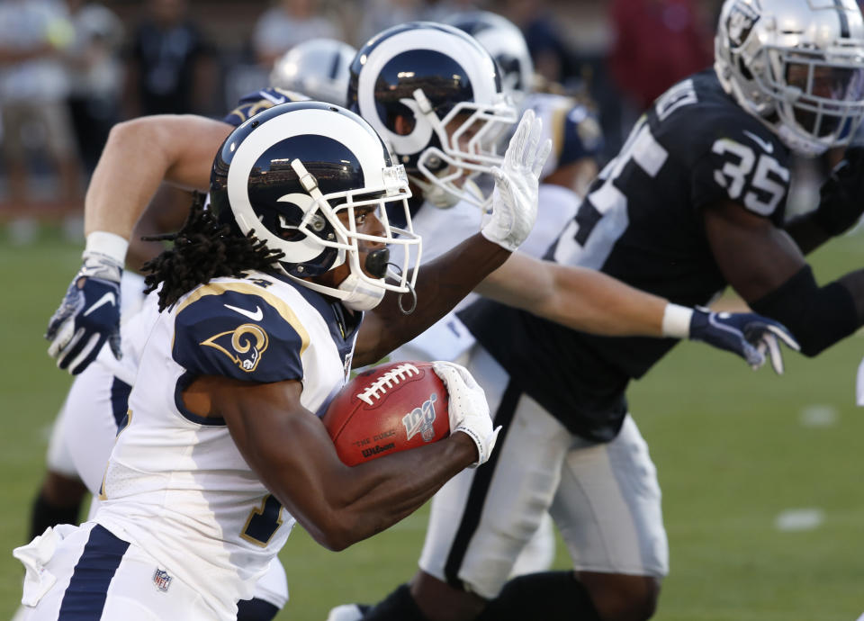 Los Angeles Rams' Nsimba Webster, left, rushes against the Oakland Raiders during the second half of a preseason NFL football game Saturday, Aug. 10, 2019, in Oakland, Calif. (AP Photo/Rich Pedroncelli)