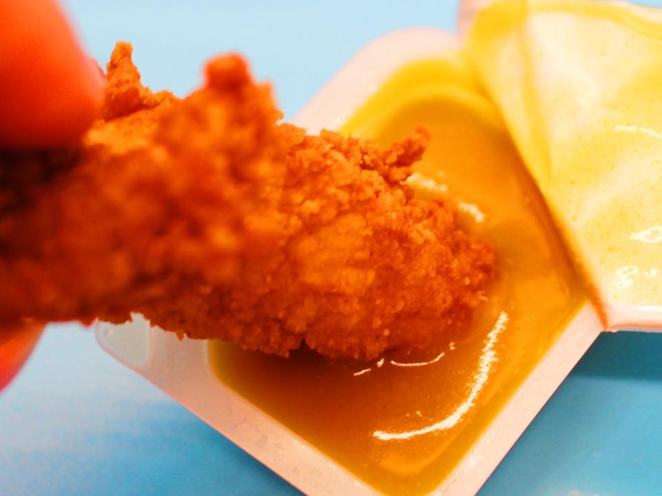chick fil a chicken tender dipped in honey mustard