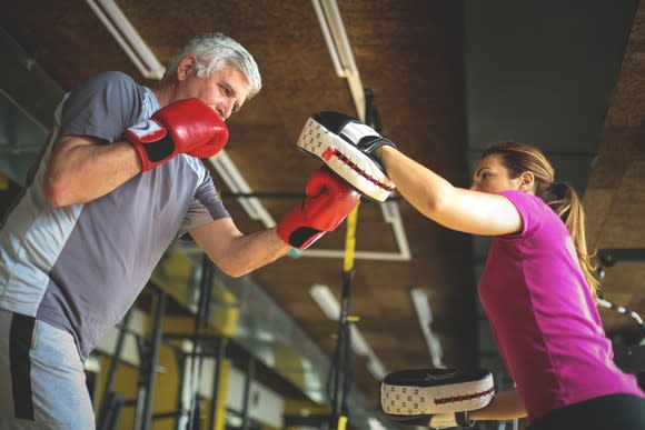 Two boxers sparring in a gym