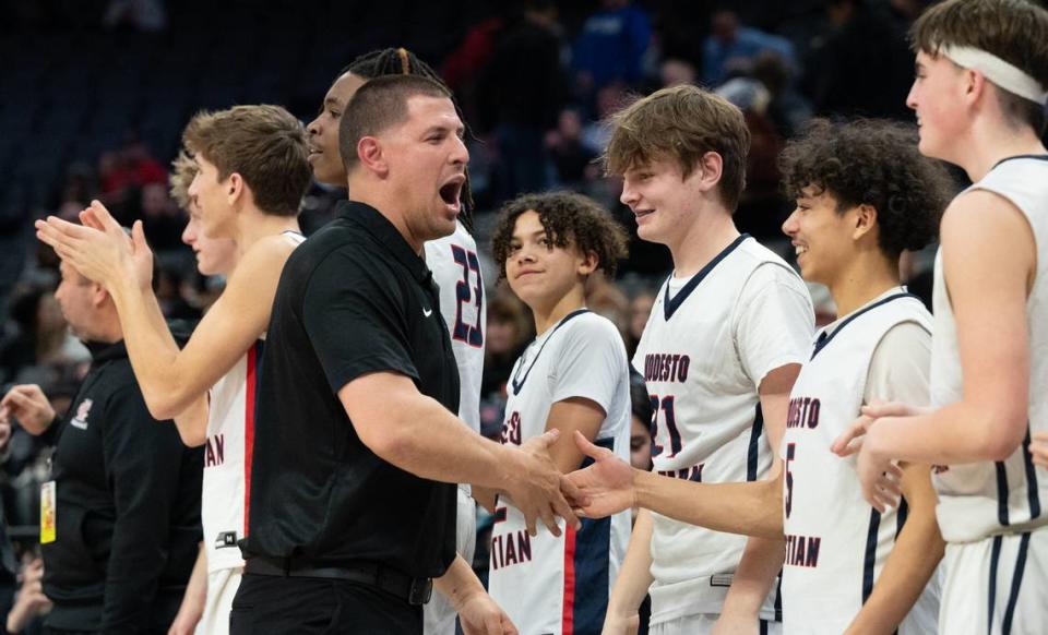 Modesto Christian coach Brice Fantazia celebrates with the bench as time expires and seals the 68-63 victory over Lincoln of Stockton in the Sac-Joaquin Section Division I championship game at the Golden 1 Center in Sacramento, Calif., Wednesday, Feb. 21, 2024.