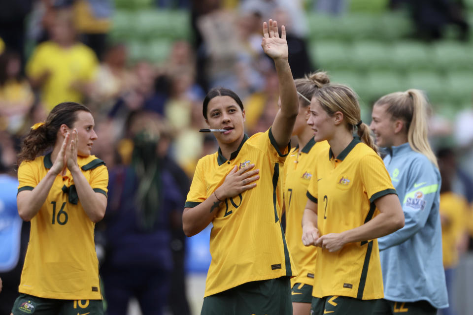Australia's Sam Kerr, center, bites on a pen as she waves after their women's friendly soccer match against Sweden in Melbourne, Australia, Saturday, Nov. 12, 2022. (Asanka Brendon Ratnayake)