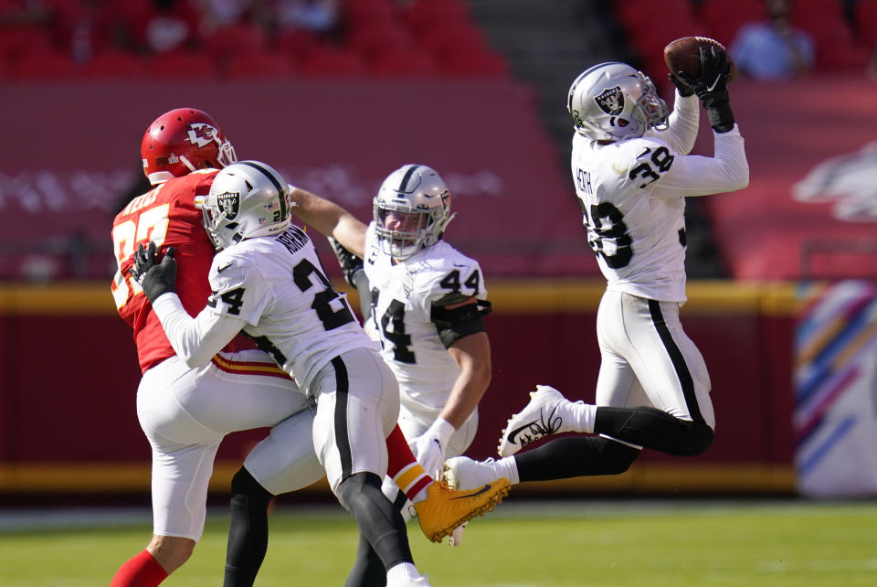 Las Vegas Raiders safety Jeff Heath (38) intercepts a pass intended for Kansas City Chiefs tight end Travis Kelce (87) during the second half of an NFL football game, Sunday, Oct. 11, 2020, in Kansas City. (AP Photo/Jeff Roberson)