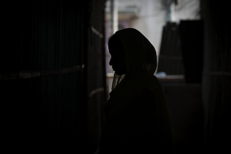 Sonali Begum, 17, stands inside her home as she cries explaining how her husband Siddique Ali, 23, was picked up by the police, at her rented house in Guwahati, India, Saturday, Feb. 4, 2023. Indian police have arrested more than 2,000 men in a crackdown on illegal child marriages in involving girls under the age of 18 a northeastern state. Begum is seven months pregnant. (AP Photo/Anupam Nath)