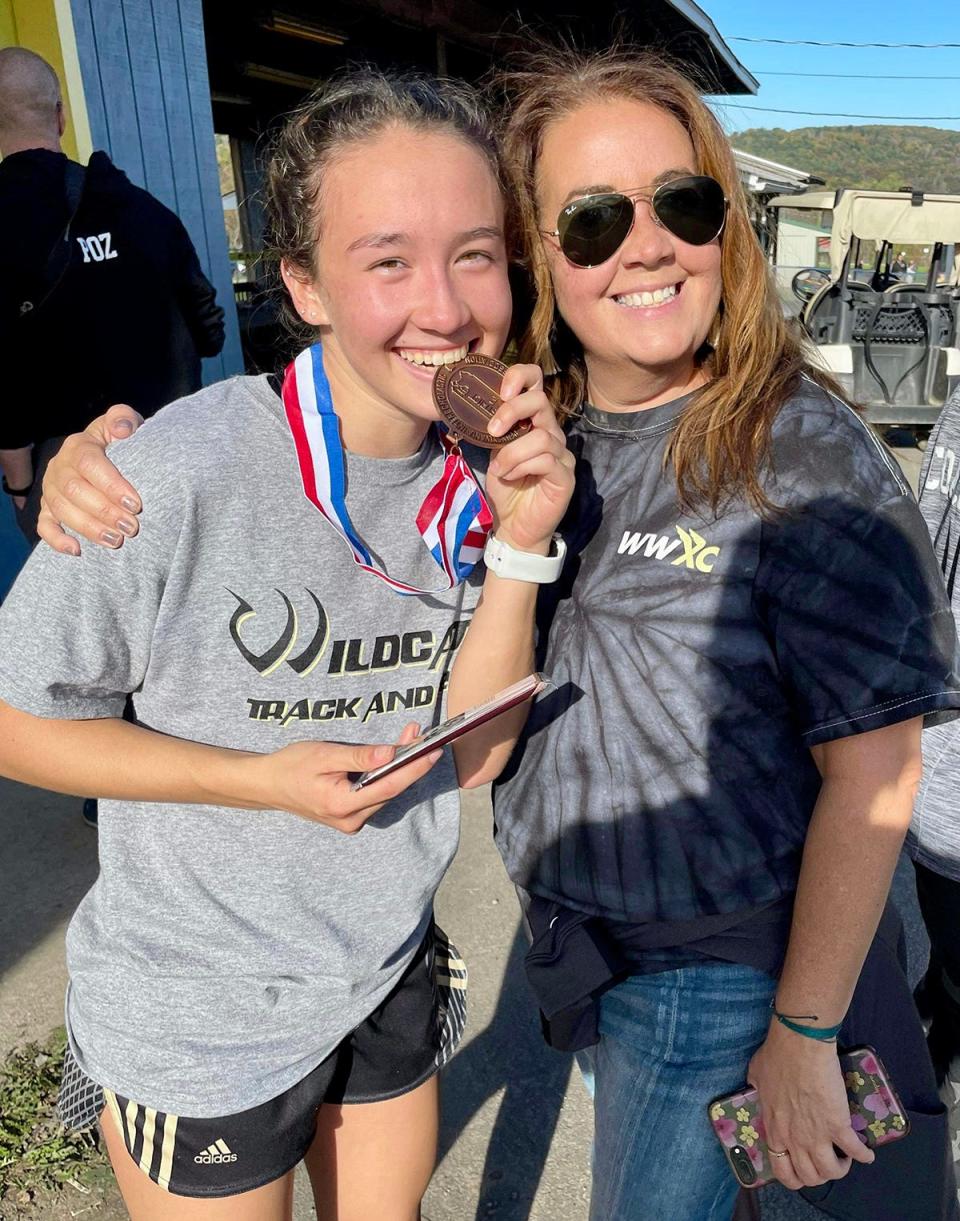 Madi Kammer, then of Western Wayne, celebrates a district medal and berth at the PIAA state cross country meet with her Mom.