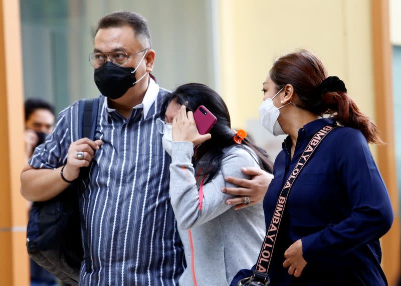 Family members of a passenger of Sriwijaya Air Flight SJ 182 react at a hospital after the plane crashed into the sea off the Jakarta coast, in Indonesia