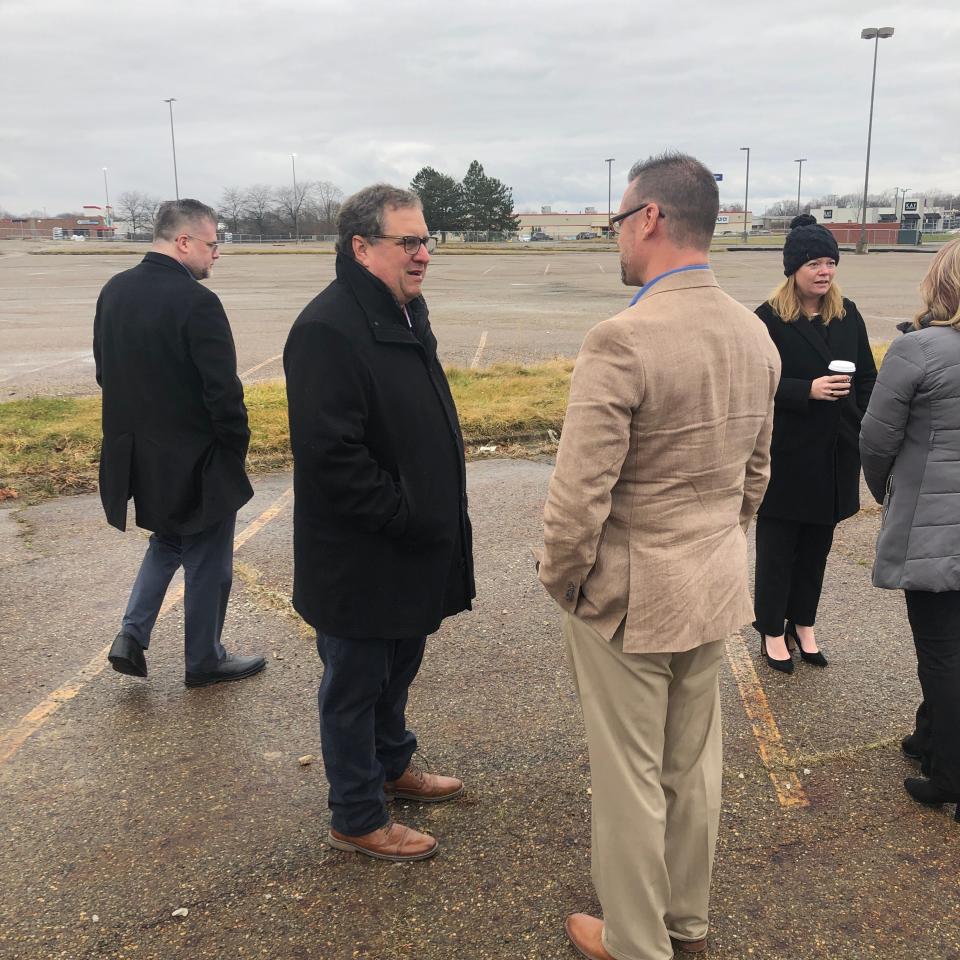 Adam Fishman, principal at Fairmount Properties, which owns the former Carnation City Mall property, talks to Rick Baxter, president of Alliance Area Development, before a groundbreaking ceremony.
