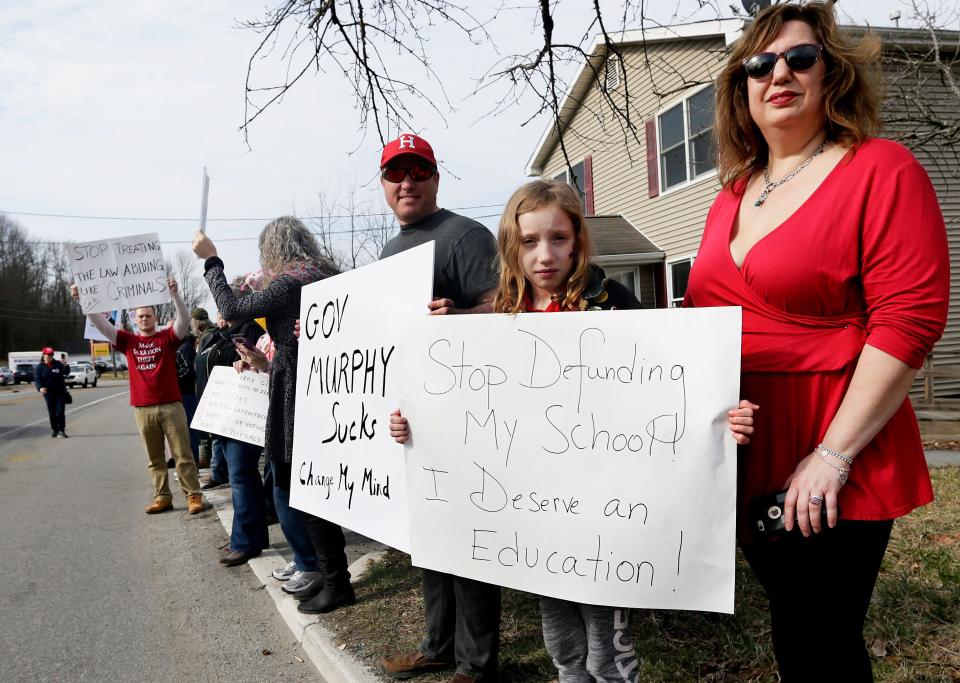 Hopatcong Borough Councilman Ryan Smith, left, joins protesters who gather across the street from the Irish Cottage in Franklin in anticipation of Gov. Phil Murphy's appearance Saturday, March 30, 2019.