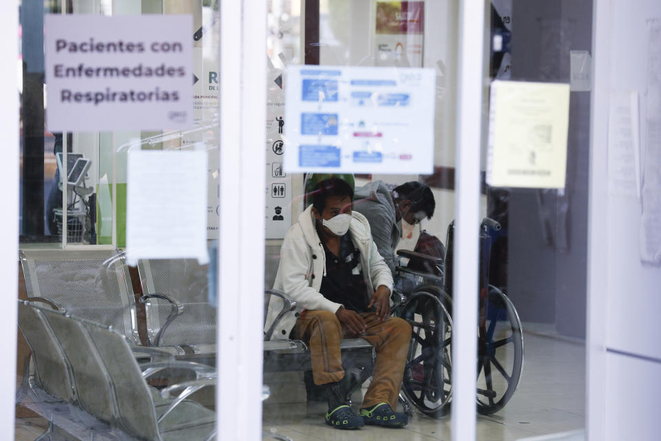 Vegetable seller Federico Rosas, 45, receives oxygen along with another patient in the waiting room of the ward designated for respiratory emergencies, at Dr. Manuel Gea Gonzalez General Hospital, one of many treating patients with symptoms of the new coronavirus, in Mexico City, Wednesday, April 22, 2020. His sister, Nancy Rosas, who was waiting outside for news, said they had brought him to the hospital the previous afternoon with flu symptoms and trouble breathing, but he hadn't yet been able to get a bed, as the respiratory ward was full. Rosas said their family of ambulatory street vendors has not been able to work for three weeks due to the new coronavirus pandemic, and their applications to receive government assistance for pay medical bills or living expenses had so far been unsuccessful. (AP Photo/Rebecca Blackwell)