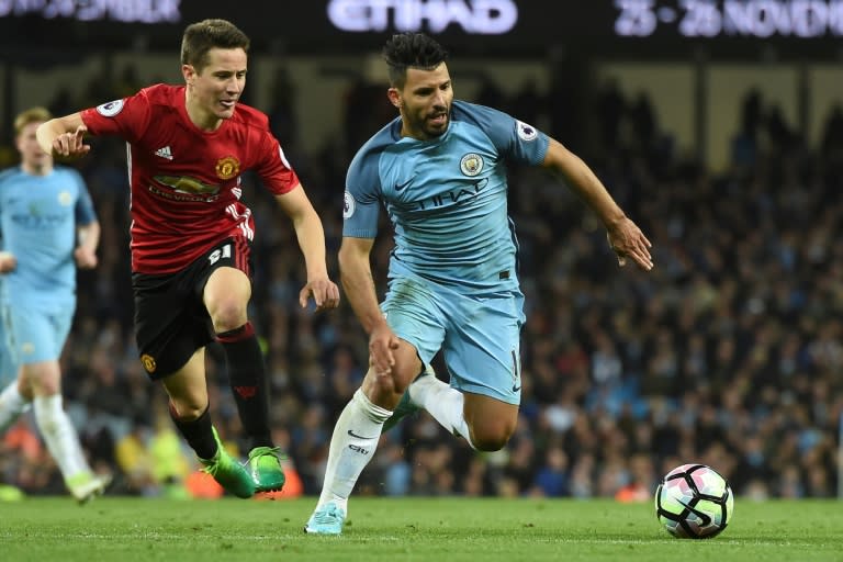 Manchester United's midfielder Ander Herrera (L) chases Manchester City's striker Sergio Aguero (R) during the English Premier League football match April 27, 2017