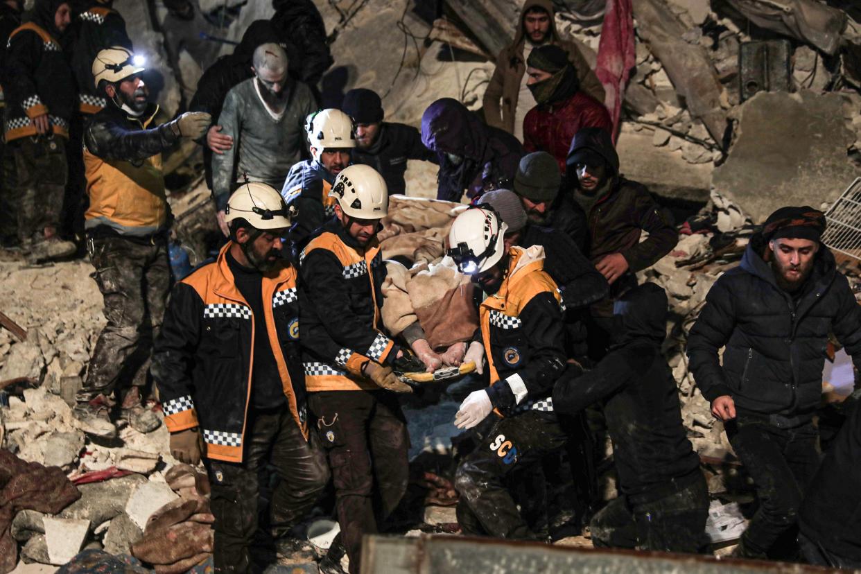 Rescue teams pull a victim out of the rubble.