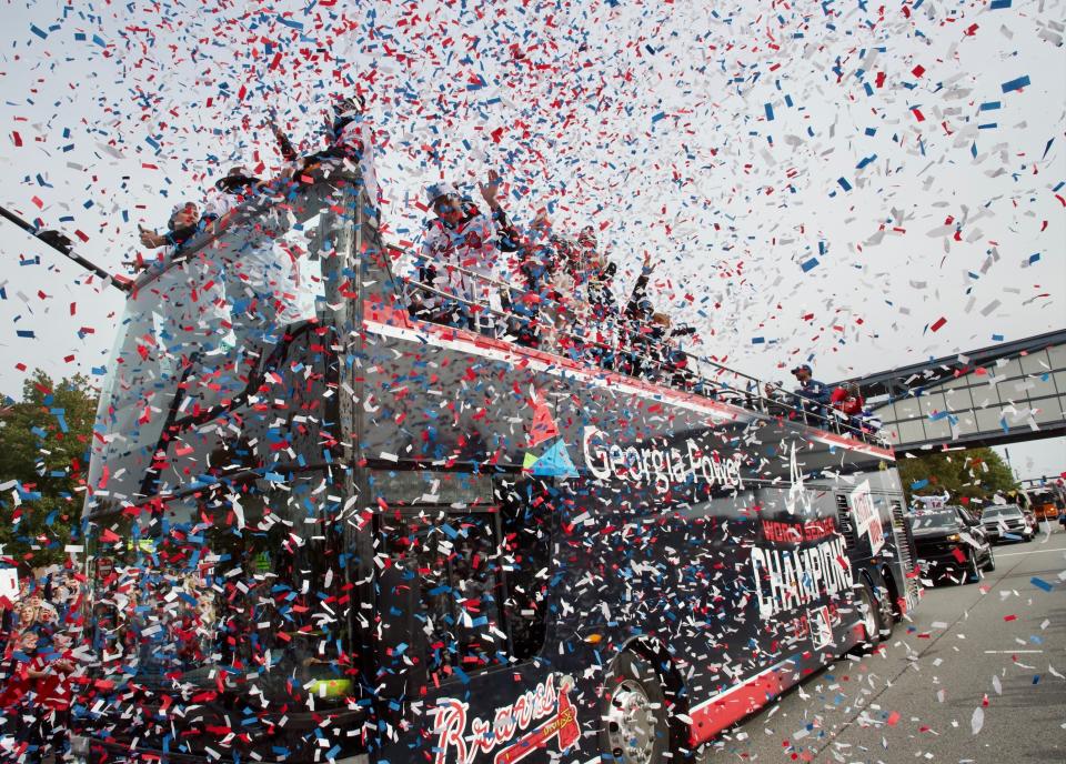 Fans cheer the 2021 World Series champion Atlanta Braves on Friday, Nov. 5, 2021, as the team parades up Cobb Parkway to Truist Park in Atlanta. (Steve Schaefer/Atlanta Journal-Constitution via AP)