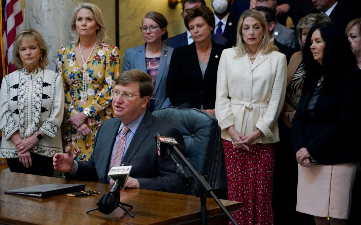 Mississippi Governor Tate Reeves signs the first state bill in the US this year to ban transgender athletes from competing on female sports teams - AP