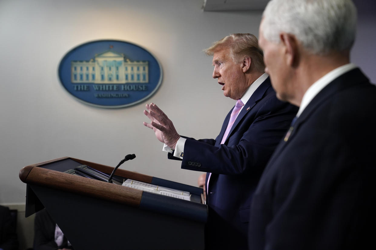 Vice President Mike Pence listens as President Donald Trump speaks during a coronavirus task force briefing at the White House, Friday, April 10, 2020, in Washington. (AP Photo/Evan Vucci)