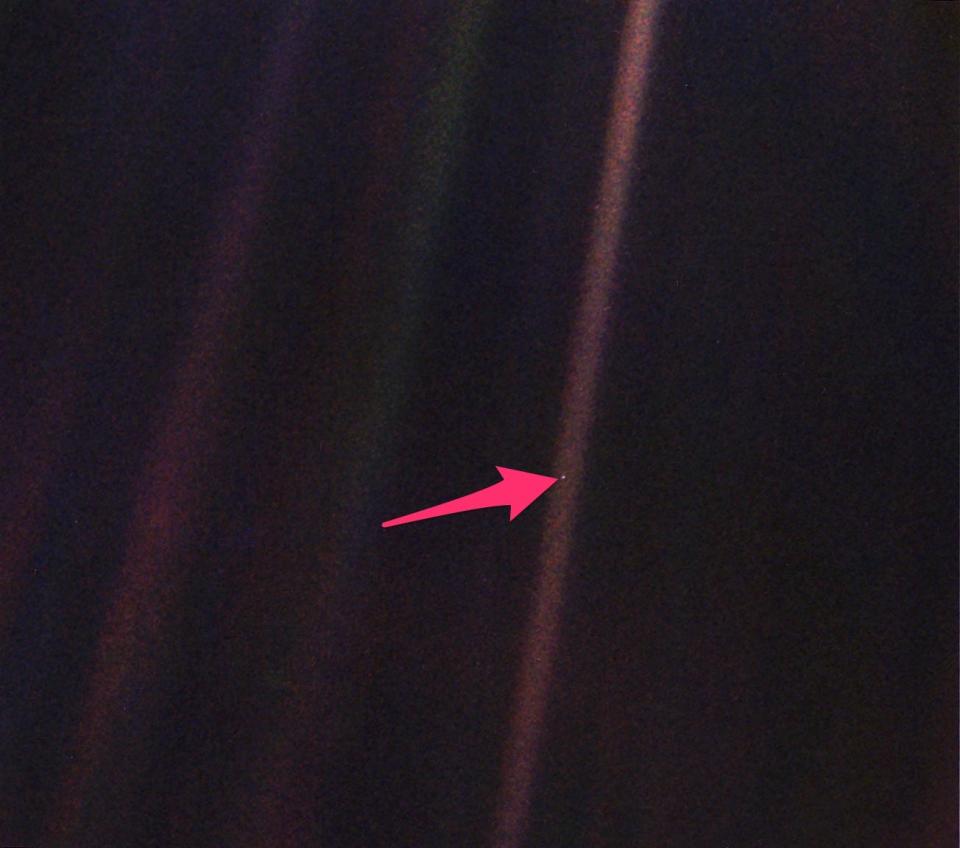 pale blue dot photo with arrow pointing to earth