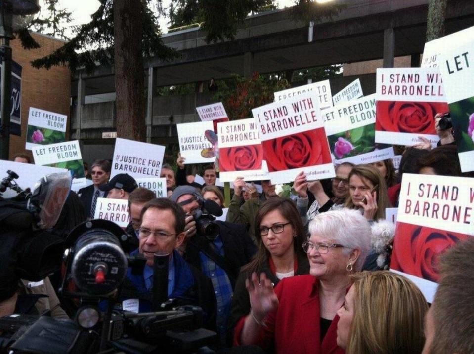 Richland florist Barronelle Stutzman, in red, talked in 2015 with supporters after her case was argued before the state Supreme Court in Bellevue. She refused to provide flowers for a gay couple’s wedding, citing her religious beliefs.