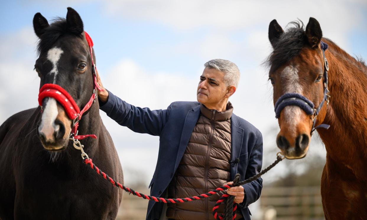 <span>Sadiq Khan at the Greengates equine therapy centre in London on Thursday.</span><span>Photograph: Leon Neal/Getty</span>