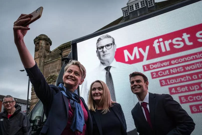 Labour's Shadow Home Secretary Yvette Cooper takes a selfie with Labour MP candidate for Bolton West Phil Brickell and Labour's candidate for Leigh and Atherton Jo Platt