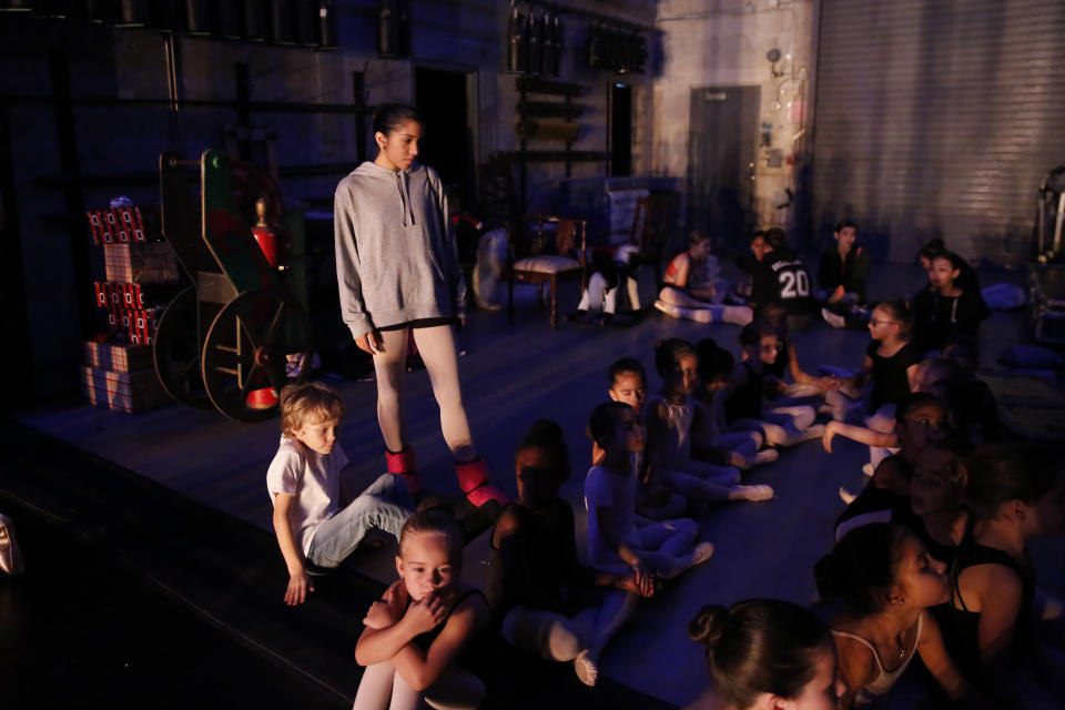 Paola Nava, 17, helps the younger dancers backstage during a rehearsal of Vladimir Issaev's rendition of The Nutcracker ballet on Friday, Dec. 13, 2019, in Fort Lauderdale, Fla. More than 20 dancers of Venezuelan origin were playing various roles on a recent performance of the holiday favorite “The Nutcracker.” Some of these dancers are here seeking asylum after fleeing their crisis-torn nation, which is plagued by shortages of food and medicine. (AP Photo/Brynn Anderson)