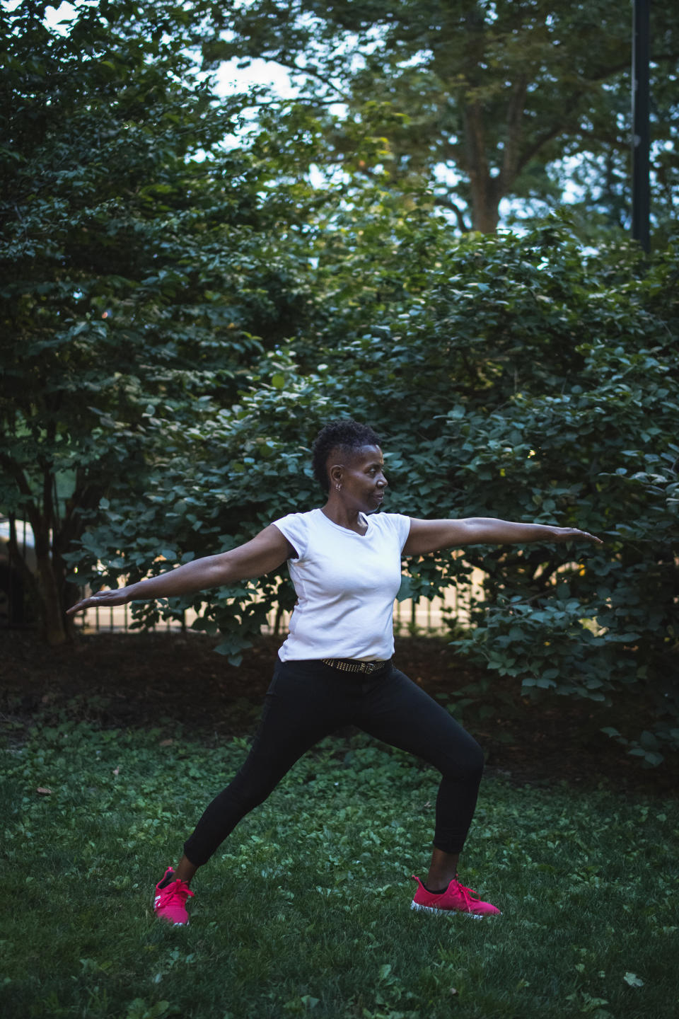 Woodson holds a yoga warrior pose in Central Park on July 16 | Kholood Eid for TIME