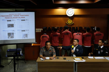 National Police Cyber Crime Director Brig. Gen. Fadil Imran (C), gestures in front of suspects arrested for cyber-crime related hoaxes on social media during a press conference in Jakarta, Indonesia February 28, 2018. Picture taken February 28, 2018. REUTERS/Darren Whiteside