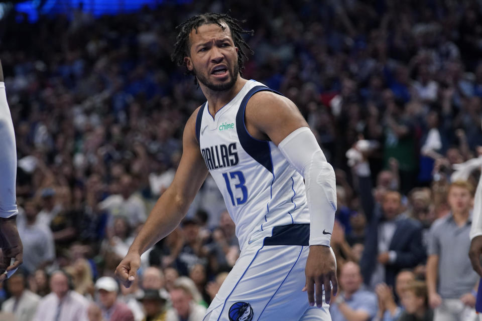 Dallas Mavericks guard Jalen Brunson (13) reacts after scoring against the Phoenix Suns during the second half of Game 3 of an NBA basketball second-round playoff series, Friday, May 6, 2022, in Dallas. (AP Photo/Tony Gutierrez)