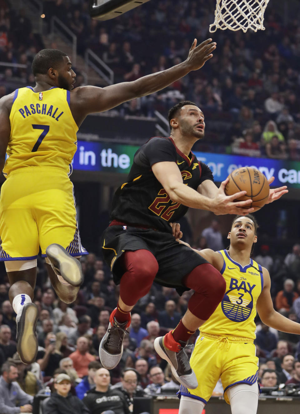 Cleveland Cavaliers' Larry Nance Jr., center, drives to the basket against Golden State Warriors' Eric Paschall, left and Jordan Poole in the first half of an NBA basketball game, Saturday, Feb. 1, 2020, in Cleveland. (AP Photo/Tony Dejak)