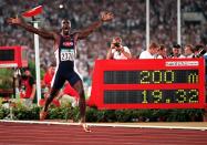 FILE - In this Aug. 1, 1996, file photo, Michael Johnson, of the United States, celebrates after he won the men's 200 meter final in a world record time of 19.32 at the 1996 Summer Olympic Games in Atlanta. (AP Photo/Doug Mills, File)