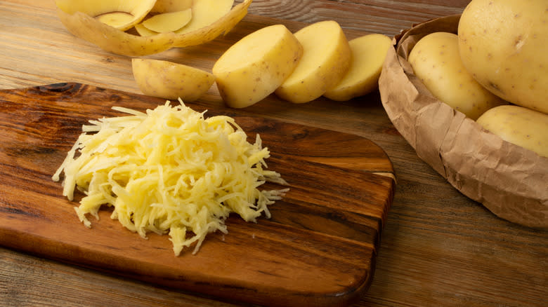 Shredded potato on cutting board