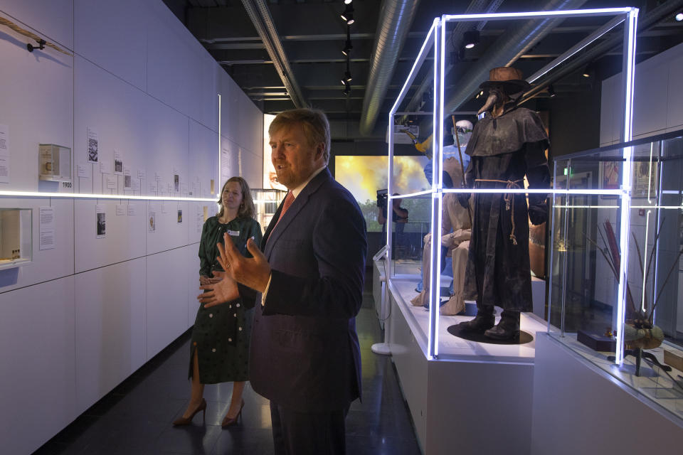 Dutch King Willem-Alexander and curator Mieneke te Hennepe, left, tour the "Contagious!" exhibit at Rijksmuseum Boerhave in Leiden, Netherlands, Thursday, July 16, 2020. The museum finally opened an exhibition Thursday on contagious diseases through the ages after a long delay caused by the disease currently sweeping the world, COVID-19. (AP Photo/Peter Dejong, Pool)