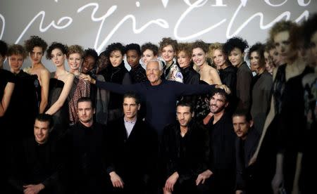 Italian designer Giorgio Armani poses with models at the end of his Autumn/Winter 2016 woman collection show during Milan Fashion Week, Italy, February 29, 2016. REUTERS/Stefano Rellandini TPX IMAGES OF THE DAY