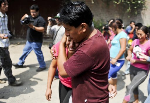 Relatives of inmates at the "Sagrado Corazon de Jesus" rehabilitation centre for drug and alcohol addicts react, after a fire swept through the place killing 14 in Lima. The sole survivor of the blaze, Luis Zeballo, told reporters he smelled smoke and felt heat in the early morning and ran out of the building