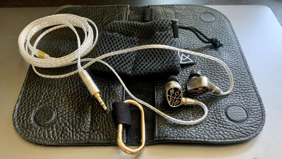 Campfire Audio Solaris Stellar Horizon on its black leather case, silver background