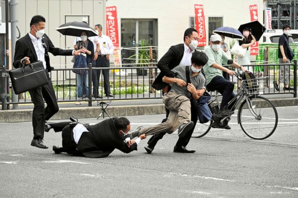 PHOTO: A man, believed to have shot former Japanese Prime Minister Shinzo Abe, is tackled by police officers in Nara, western Japan on July 8, 2022. (Asahi Shimbun via Reuters)