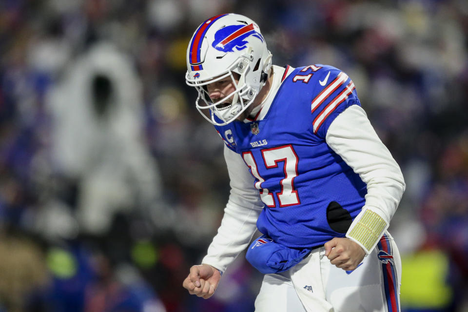 Buffalo Bills quarterback Josh Allen (17) reacts after wide receiver Emmanuel Sanders (1) catches a touchdown pass during the second half of an NFL wild-card playoff football game against the New England Patriots, Saturday, Jan. 15, 2022, in Orchard Park, N.Y. (AP Photo/Joshua Bessex)