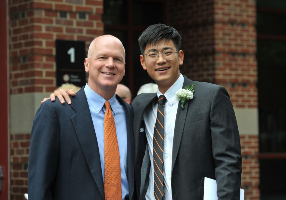 Thayer Academy teacher Kevin Cedrone, left, joins class valedictorian Jiajun Chen for a picture after the Class of 2023 commencement in Braintree on Saturday, June 10, 2023.